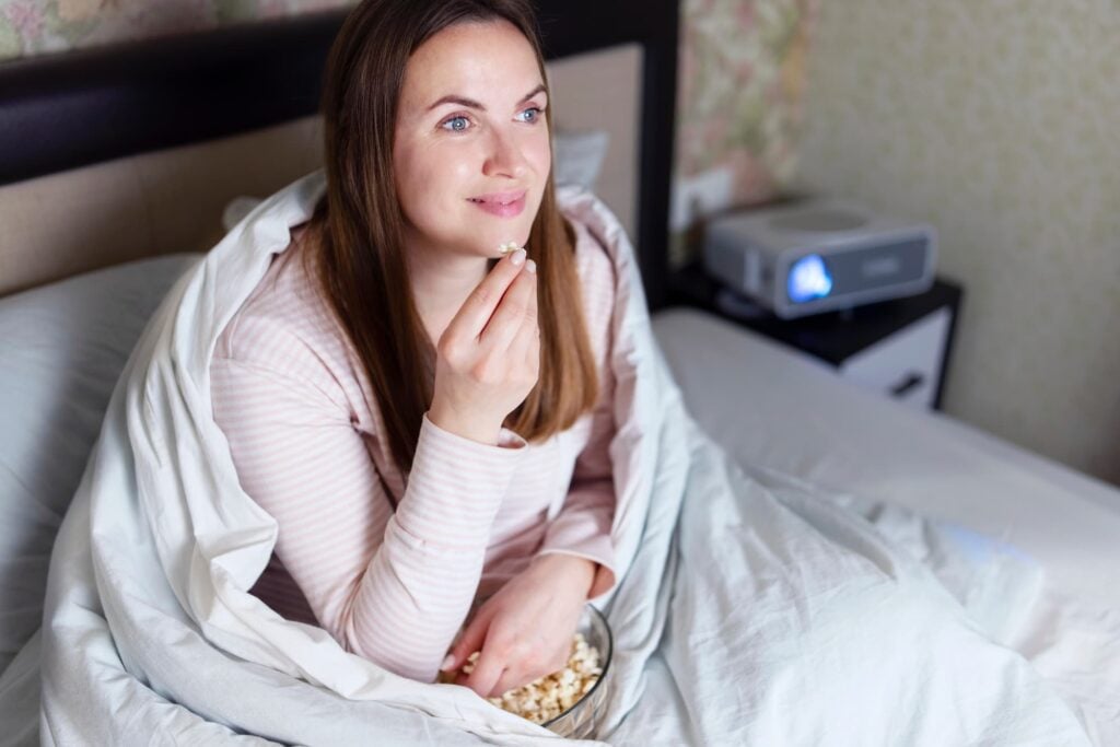 Girl watching movie with popcorn